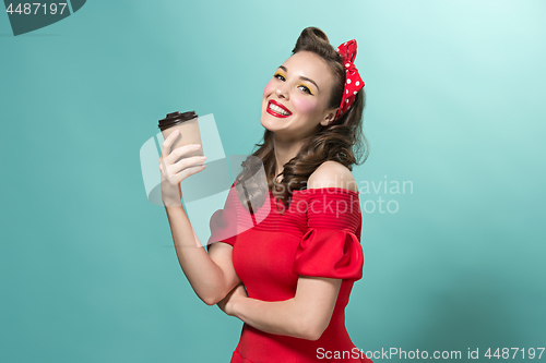 Image of Beautiful young woman with pinup make-up and hairstyle. Studio shot on white background