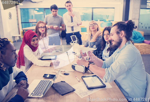 Image of multiethnic business team learning about drone technology