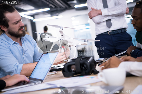 Image of multiethnic business team learning about drone technology