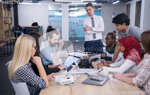 Image of multiethnic business team learning about drone technology