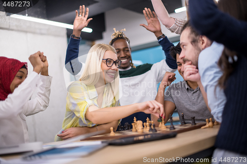 Image of multiethnic group of business people playing chess