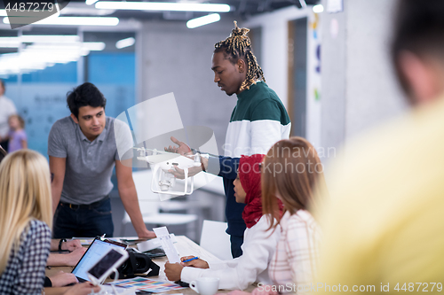 Image of multiethnic business team learning about drone technology