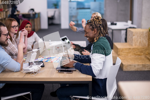 Image of multiethnic business team learning about drone technology