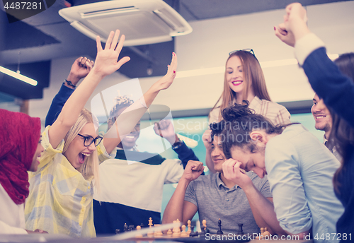 Image of multiethnic group of business people playing chess