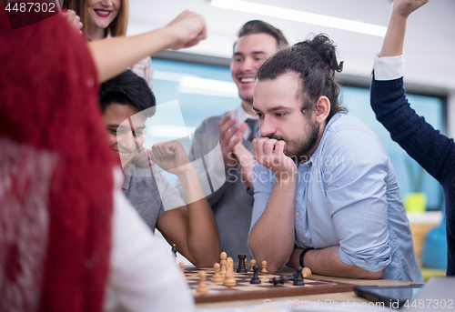 Image of multiethnic group of business people playing chess