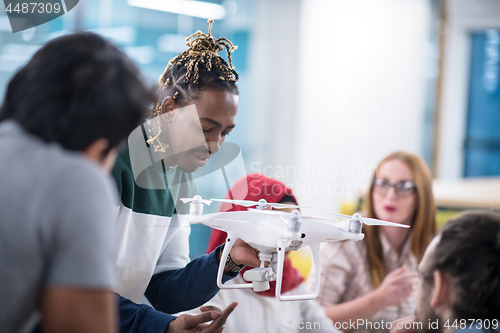 Image of multiethnic business team learning about drone technology