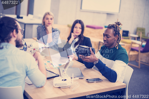 Image of Young Multiethnic Business team using virtual reality headset