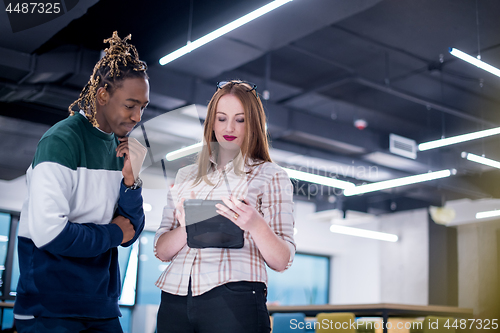 Image of multiethnic business couple using a tablet computer