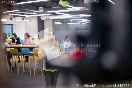 Image of blonde businesswoman working online using digital tablet