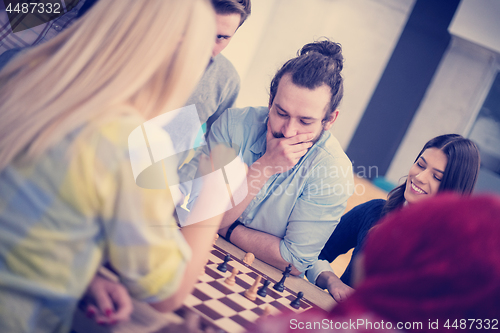 Image of multiethnic group of business people playing chess