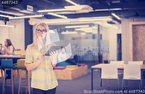 Image of blonde businesswoman working online using digital tablet