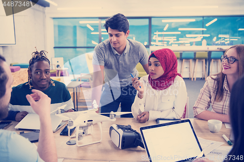 Image of multiethnic business team learning about drone technology