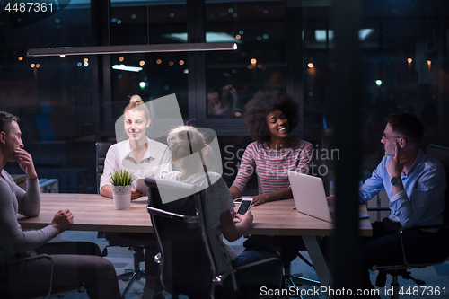 Image of Multiethnic startup business team in night office