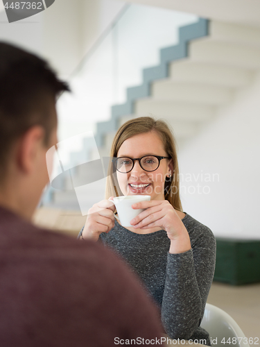 Image of couple enjoying morning coffee and strawberries