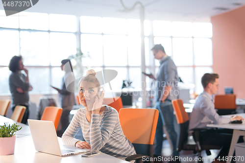 Image of businesswoman using a laptop in startup office