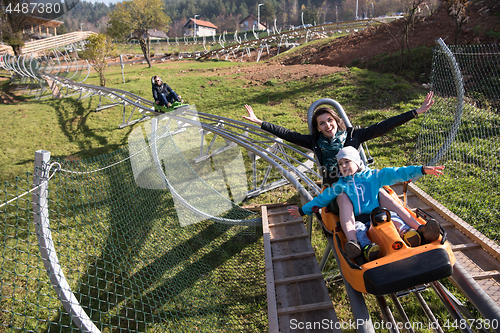 Image of mother and son enjoys driving on alpine coaster