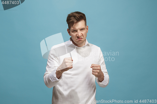 Image of The young emotional angry man screaming on studio background