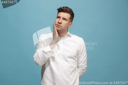 Image of Young serious thoughtful businessman. Doubt concept.