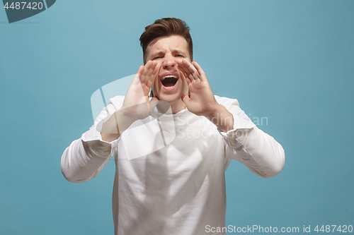 Image of Isolated on pink young casual man shouting at studio