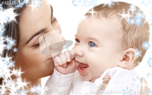 Image of smiling baby in mother hands