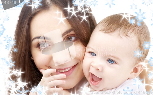 Image of smiling baby in mother hands