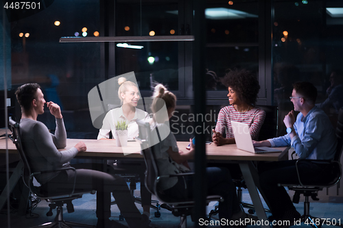 Image of Multiethnic startup business team in night office