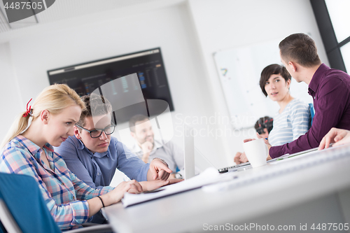 Image of Two Business People Working With laptop in office