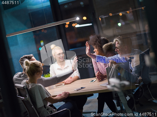 Image of Multiethnic startup business team in night office