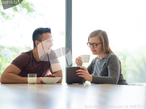 Image of couple enjoying morning coffee and strawberries