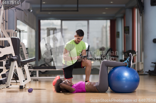 Image of pilates  workout with personal trainer at gym