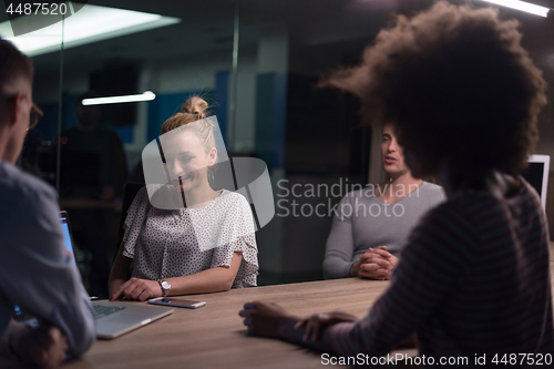 Image of Multiethnic startup business team in night office