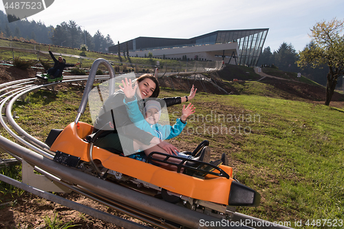 Image of mother and son enjoys driving on alpine coaster