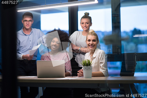 Image of Multiethnic startup business team in night office
