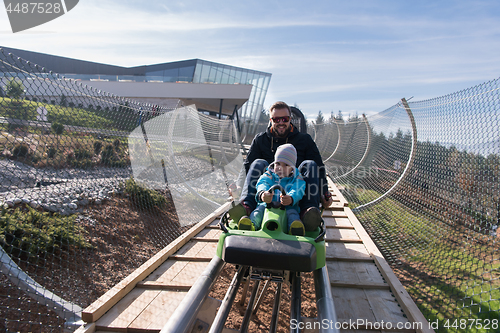 Image of father and son enjoys driving on alpine coaster