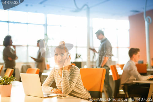 Image of businesswoman using a laptop in startup office