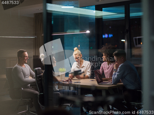 Image of Multiethnic startup business team in night office