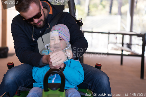 Image of father and son enjoys driving on alpine coaster