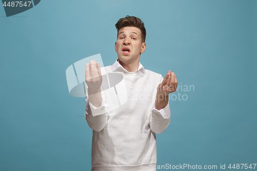 Image of Beautiful male half-length portrait isolated on studio backgroud. The young emotional surprised man