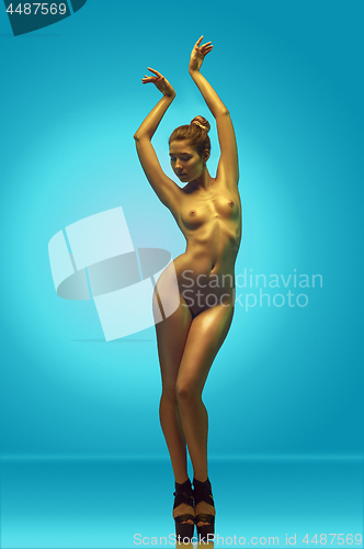 Image of fashion art photo of elegant nude model in the light colored spotlights