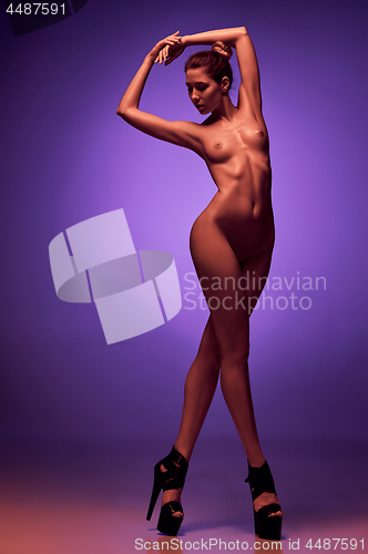 Image of fashion art photo of elegant nude model in the light colored spotlights