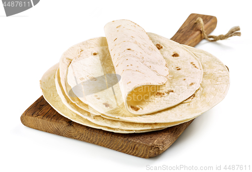 Image of empty tortillas on wooden cutting board