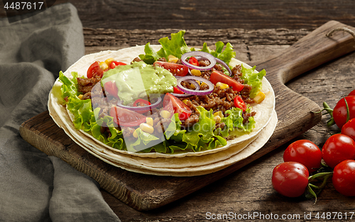 Image of Tortilla wrap with fried minced meat and vegetables 