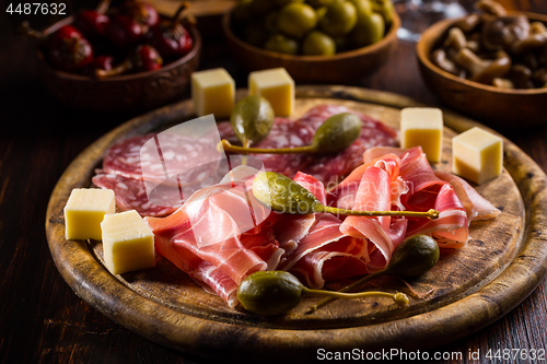 Image of Serrano ham platter with variation of appetizers