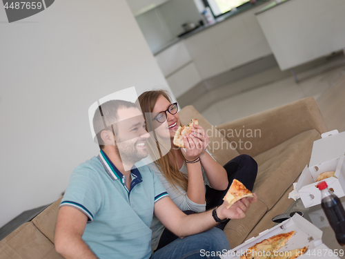 Image of couple eating pizza in their luxury home villa
