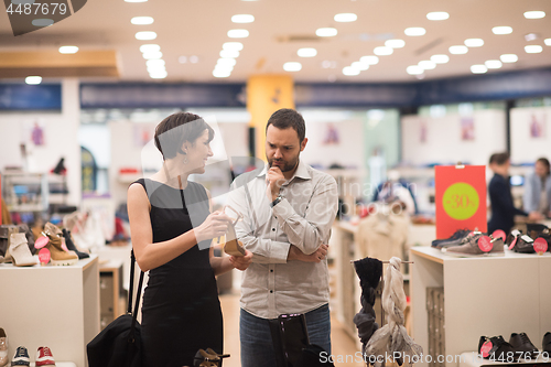 Image of couple chooses shoes At Shoe Store