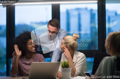 Image of Multiethnic startup business team in night office