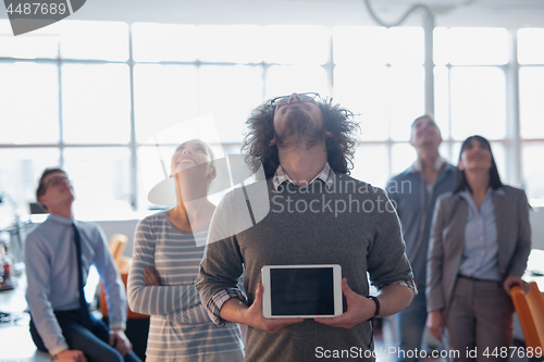 Image of Portrait of a young businessman holding tablet