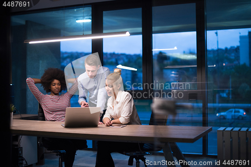 Image of Multiethnic startup business team in night office