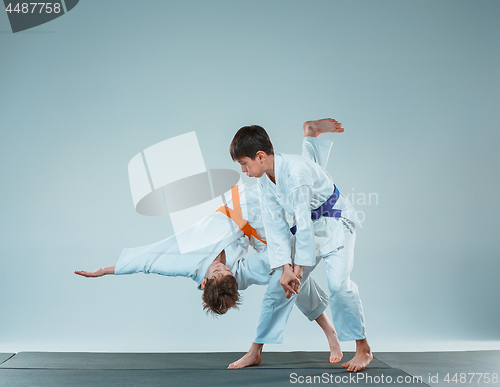 Image of The two boys fighting at Aikido training in martial arts school. Healthy lifestyle and sports concept