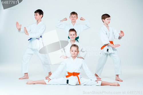 Image of The group of boys and girl fighting at Aikido training in martial arts school. Healthy lifestyle and sports concept